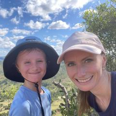 Lady with young boy smiling with landscape view in background