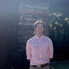 Man standing beside sign