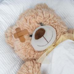 Teddy bear with band aid on head