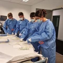 UQ medical students putting on surgery gowns